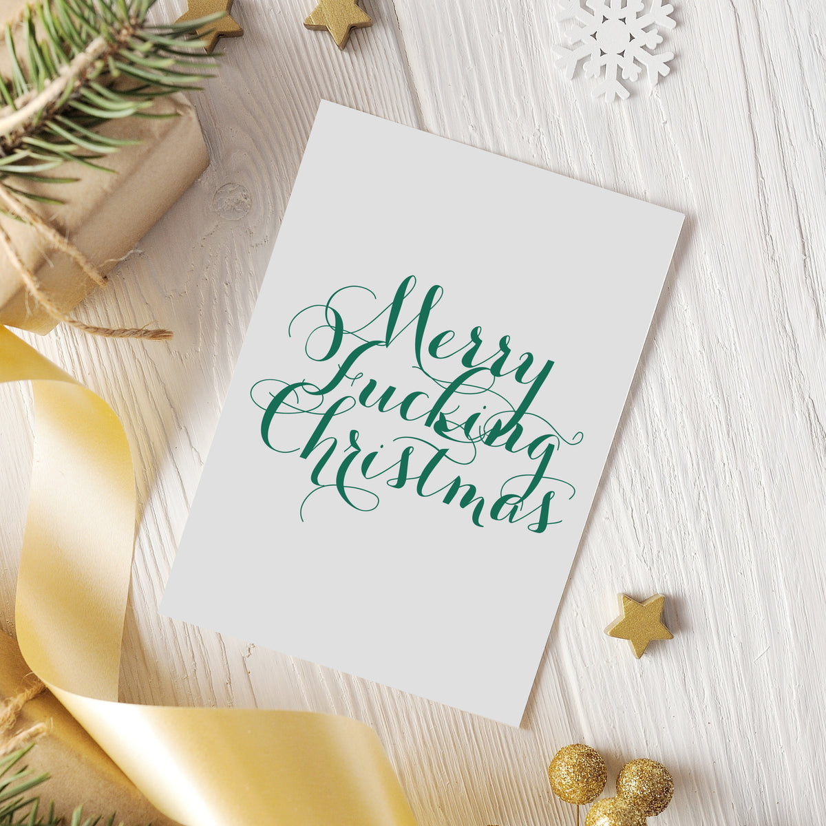 Set of 24 holiday cards with 12 designs combining profanity-based phrases and seasonal illustrations.