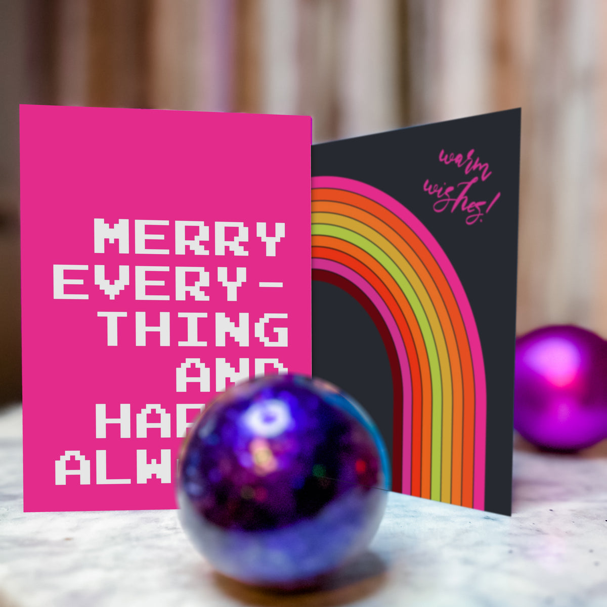 Christmas cards and envelopes in illustrated and typographic styles with bright, saturated color palettes.