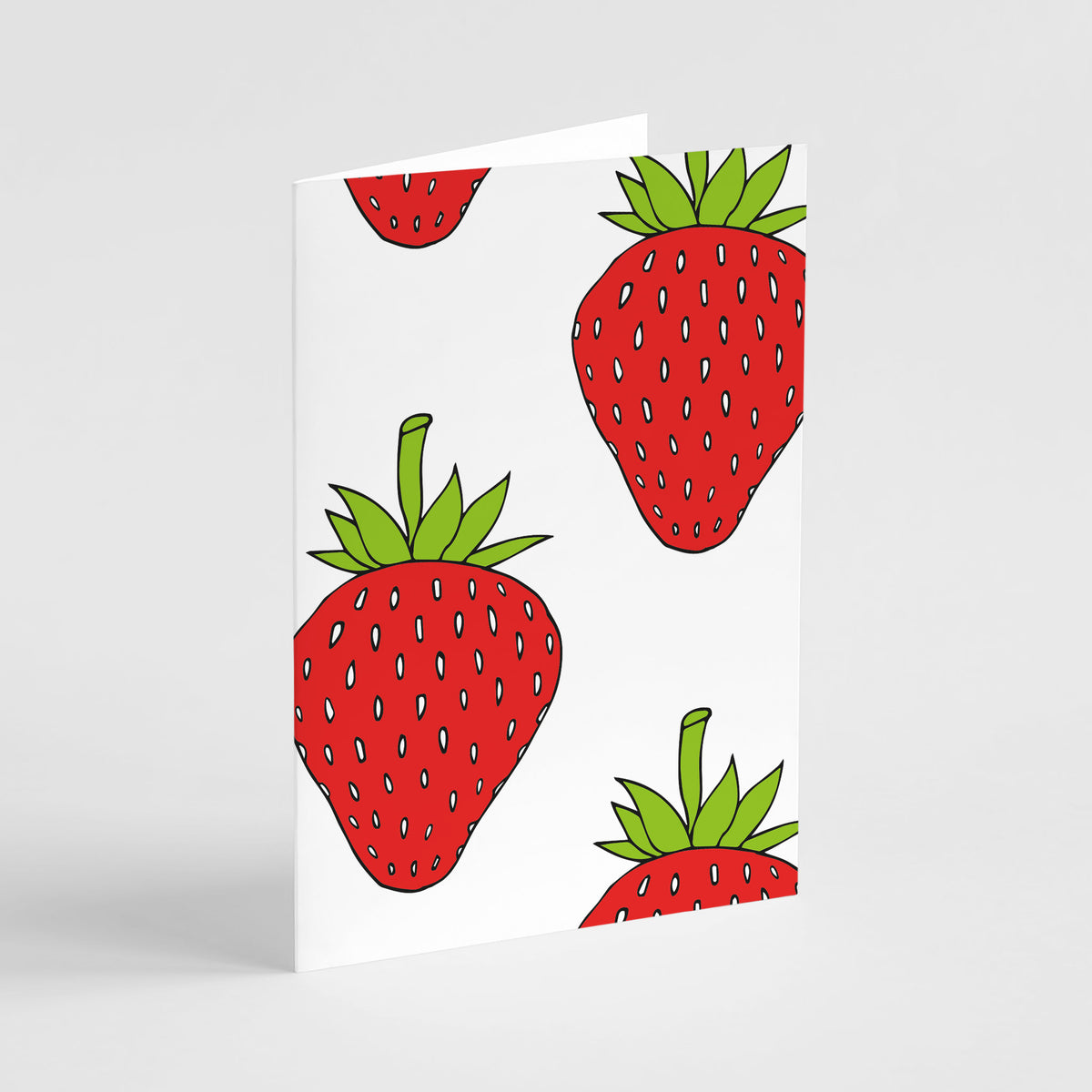 Notecards with evenly spaced strawberry motifs in red, green, blue, and yellow.