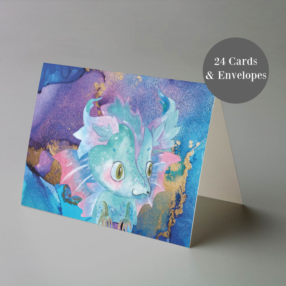 Twenty-four-piece folded greeting card set with full-bleed hand-drawn watercolor dragon designs in a colorful fantasy illustr