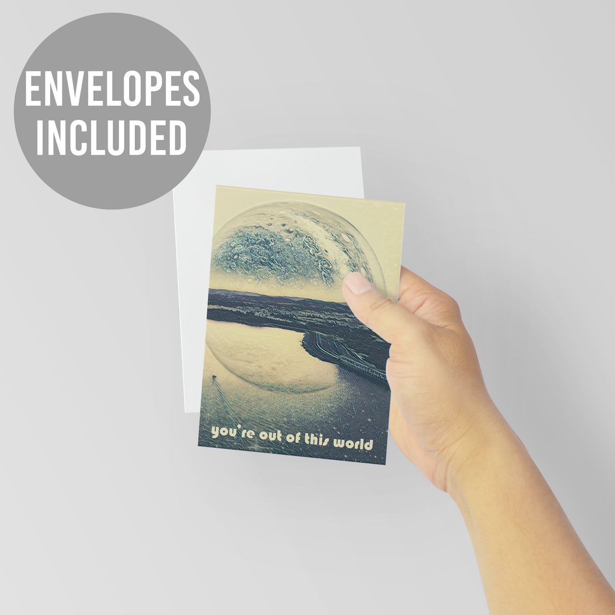 Identical cards with a digitally rendered planet and coastal scene in slate-blue, sandy cream, and muted gray tones.