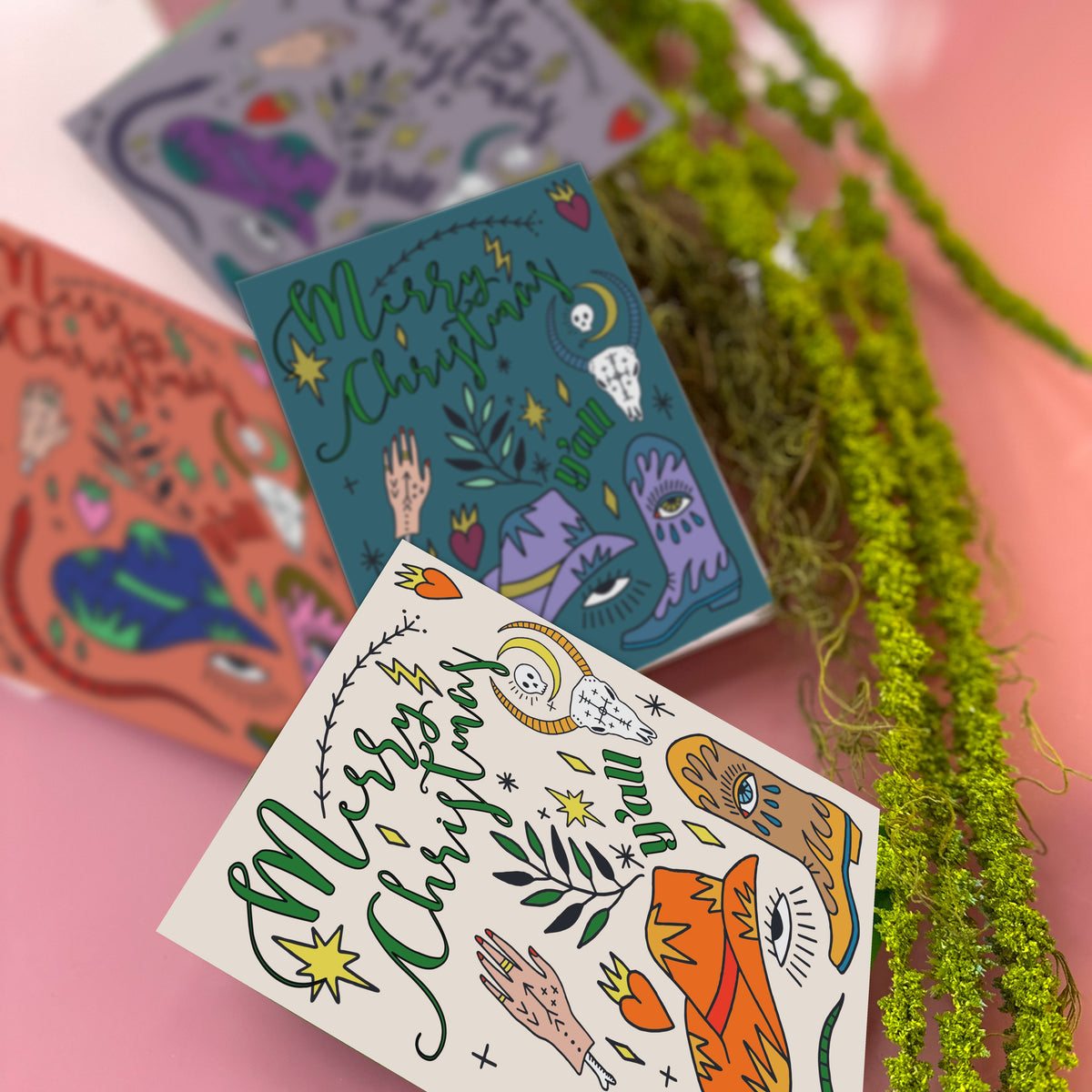 Four-design Christmas card assortment; all designs share identical layout with motifs distributed across mid and lower card a