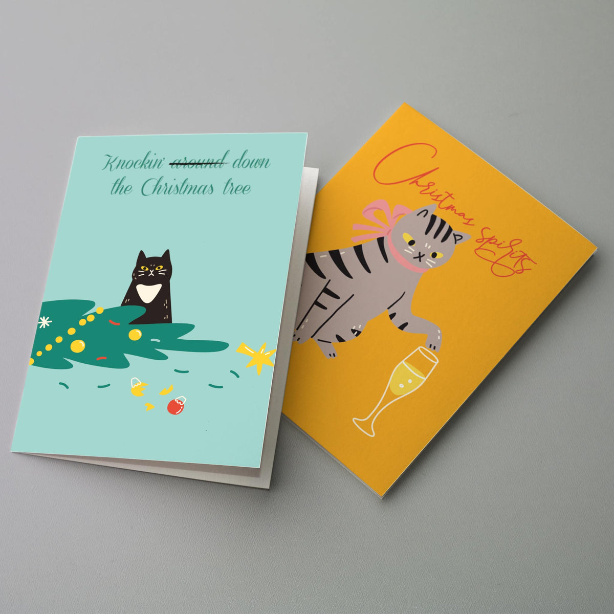 Cat Christmas card set with designs including a tree-shaped cat in lights and a kitten atop a potted tree.