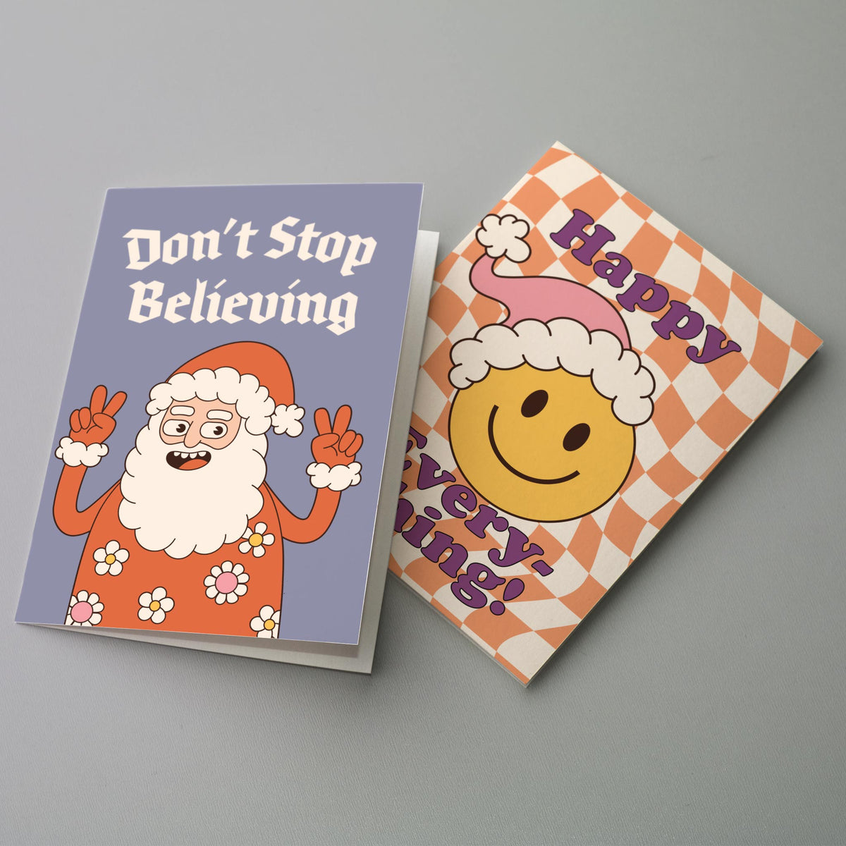 Folded holiday cards in a retro 1970s style with slab and bubble display lettering and cartoon character illustrations.