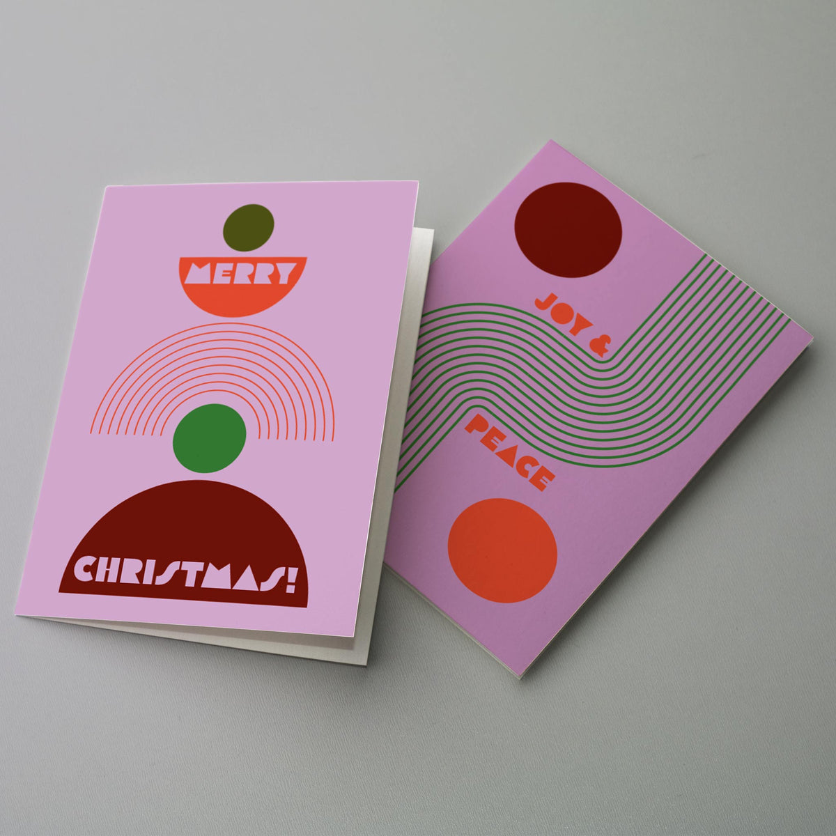 Flat geometric holiday card set, 6 designs, 4 cards each, with concentric arch and circle motifs in boho tones.