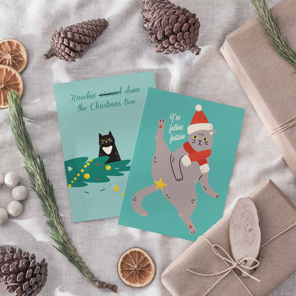 Christmas card set with 12 rotating designs, each pairing a cat illustration with a holiday joke.