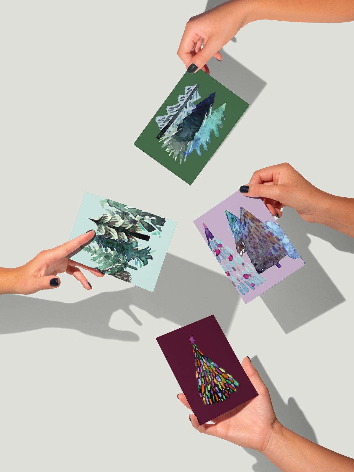 Christmas card set featuring angular trees in multicolor daub and scaled patterns across 12 designs.