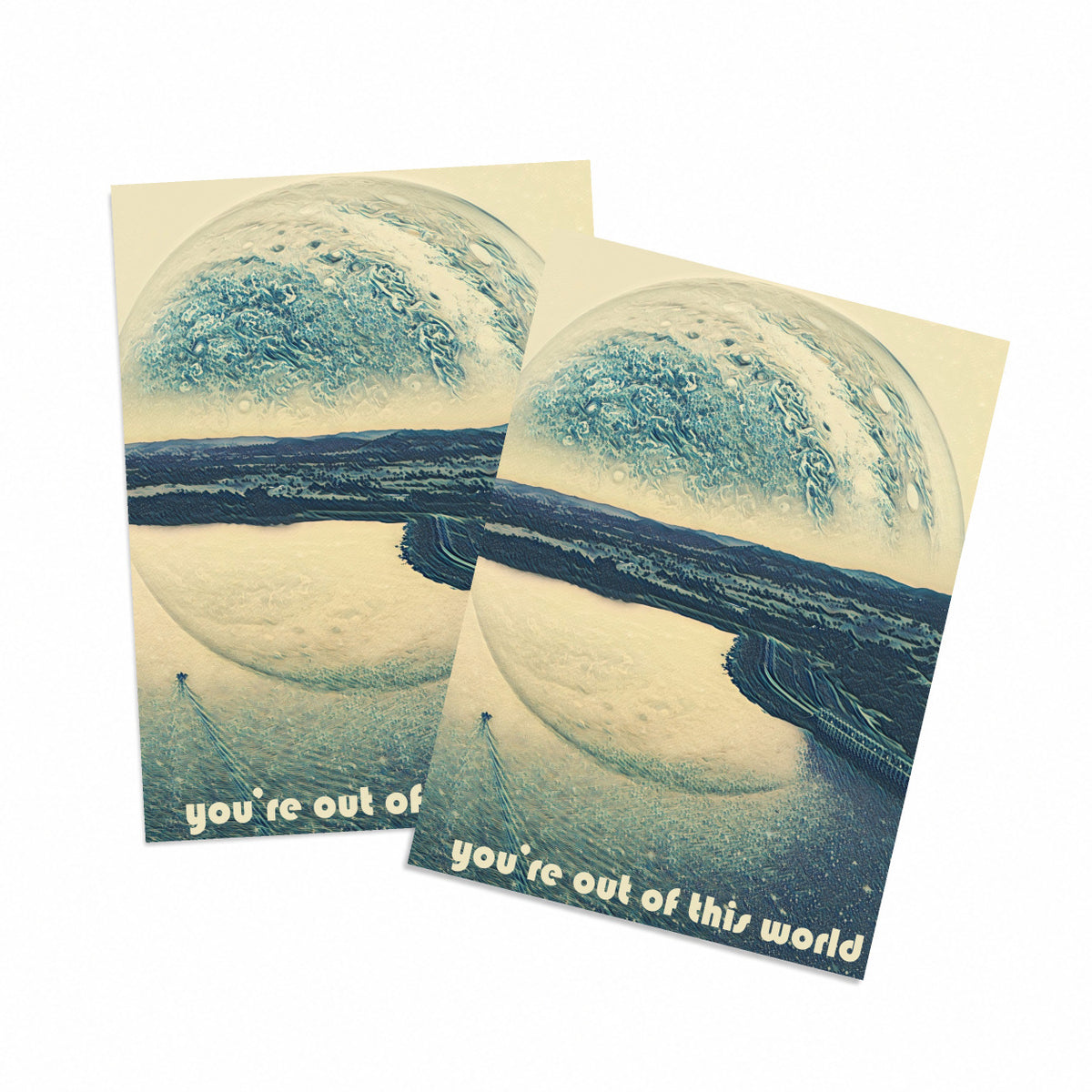 "You're Out of This World" card with surrealistic planet and coastal landscape illustration in muted blue and cream tones.