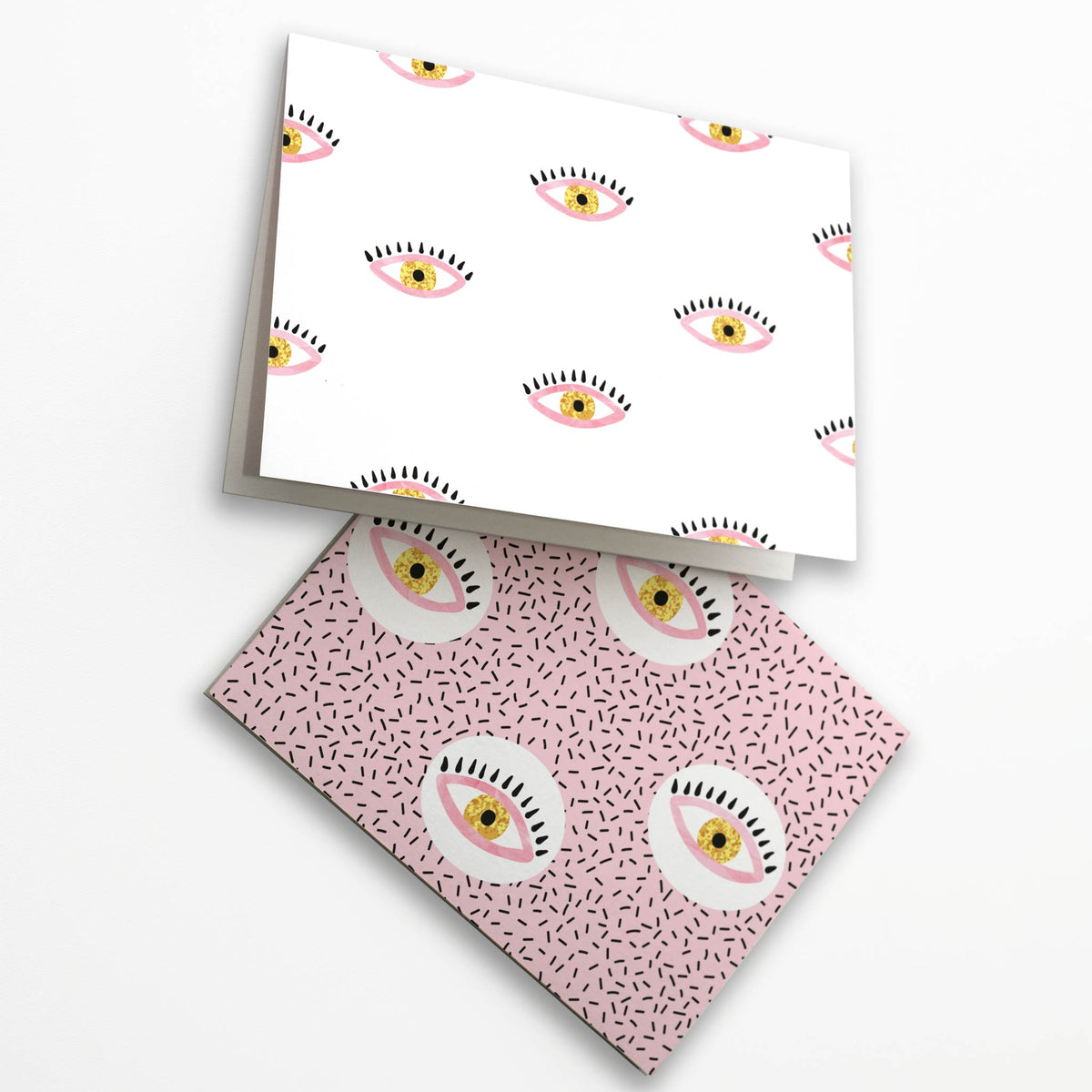 Eye pattern notecard set with 24 cards featuring illustrated eye motifs on pink and white patterned backgrounds.