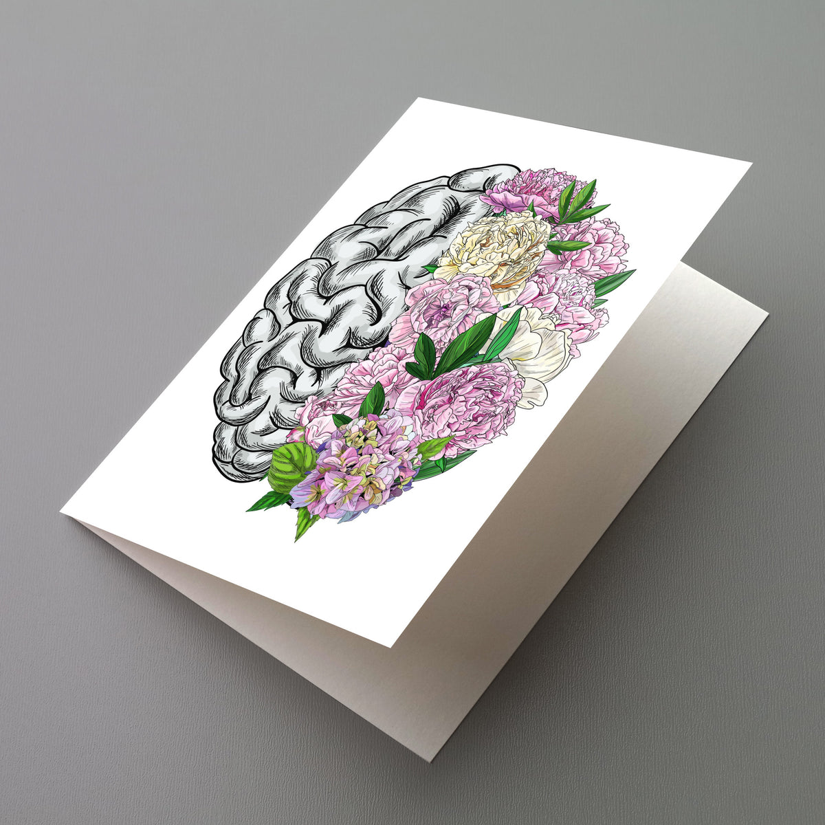 Greeting card with a top-down brain illustration, left half in black-and-white engraving style, right half in painted peonies