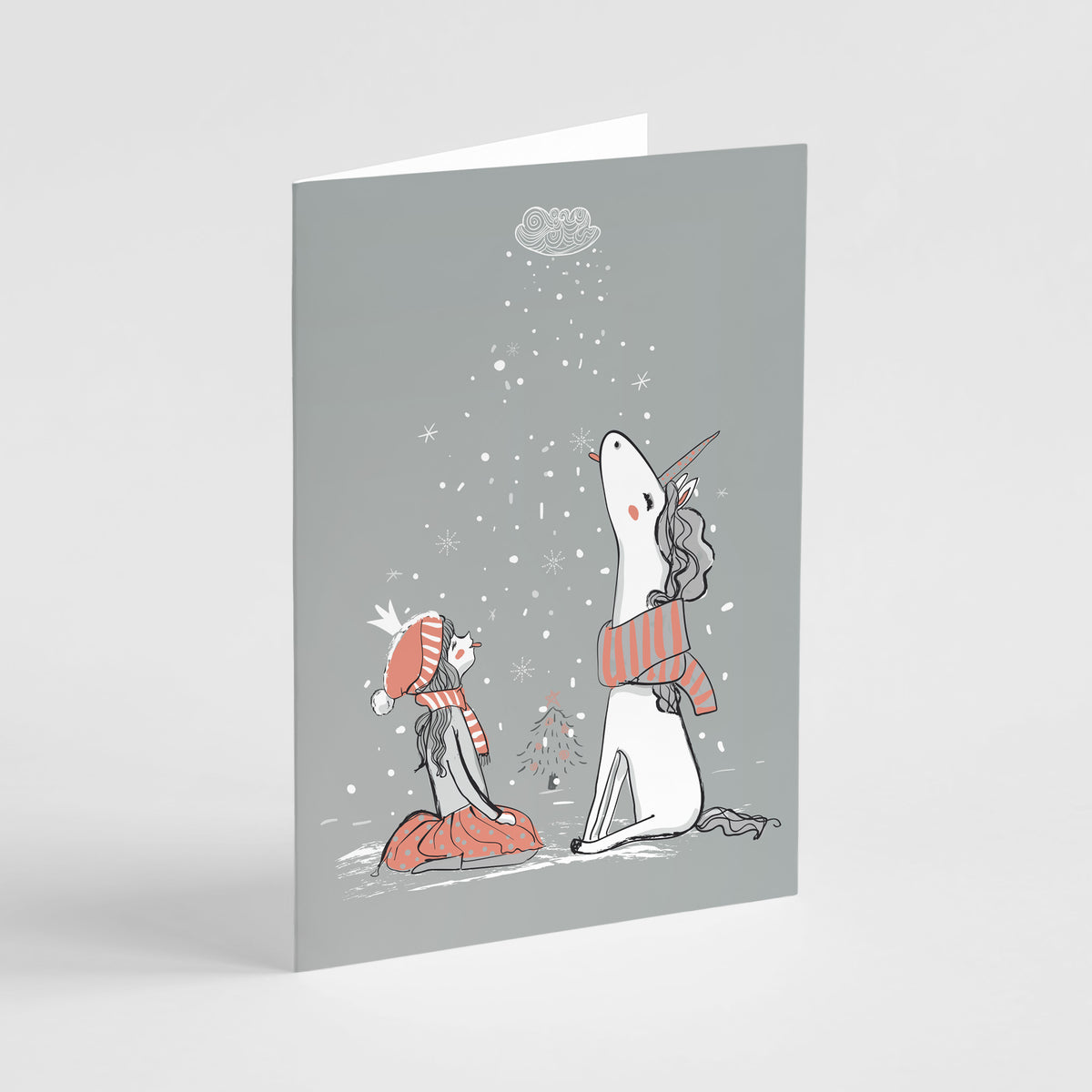 Pack of 24 cards featuring a line-drawn girl and unicorn in red and white striped scarves with a small Christmas tree.