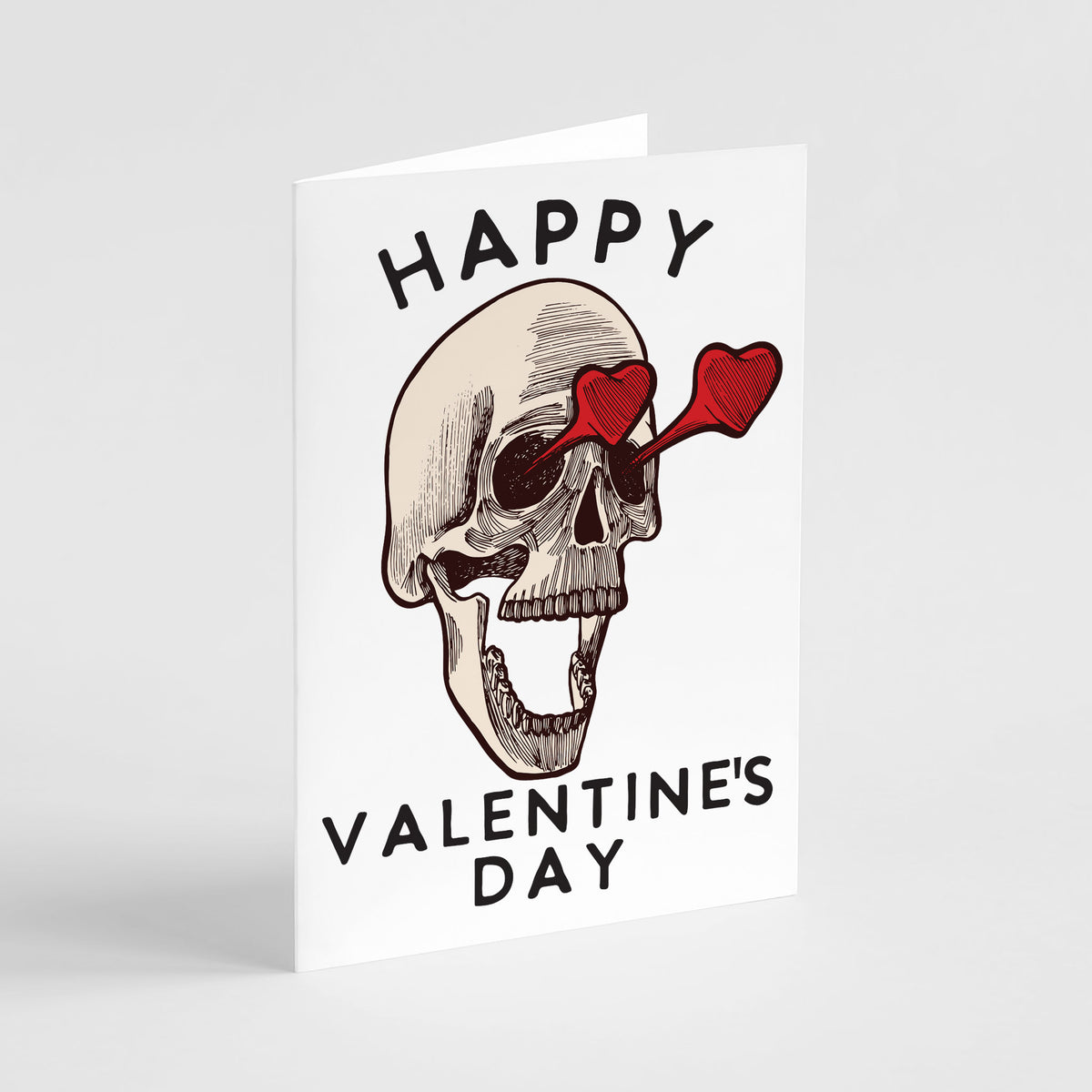 Card boxed set featuring a cross-hatched skull illustration with red heart glasses and all-caps Valentine's Day lettering.