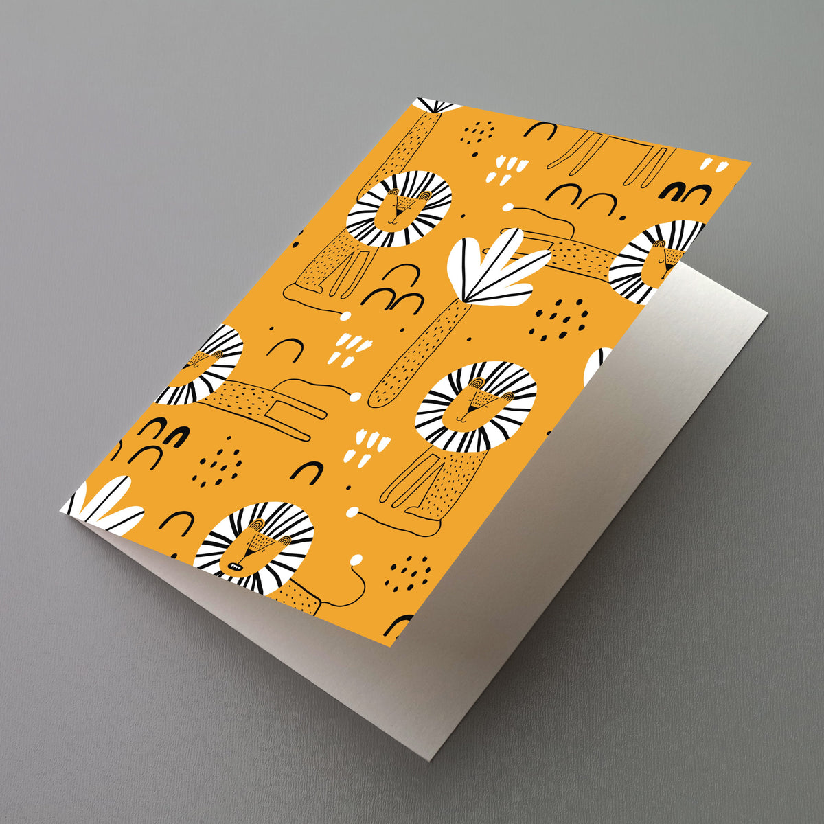 Greeting cards featuring a repeating line-drawn lion pattern on a mustard yellow background.