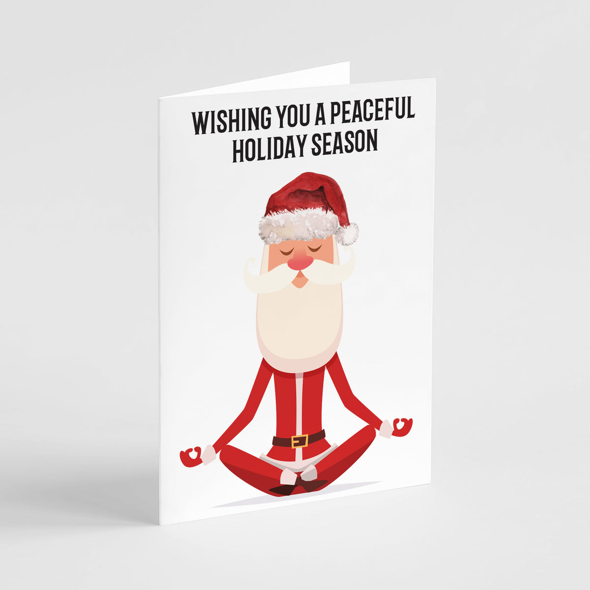 Holiday cards featuring an illustrated Santa Claus seated in a cross-legged meditation pose.