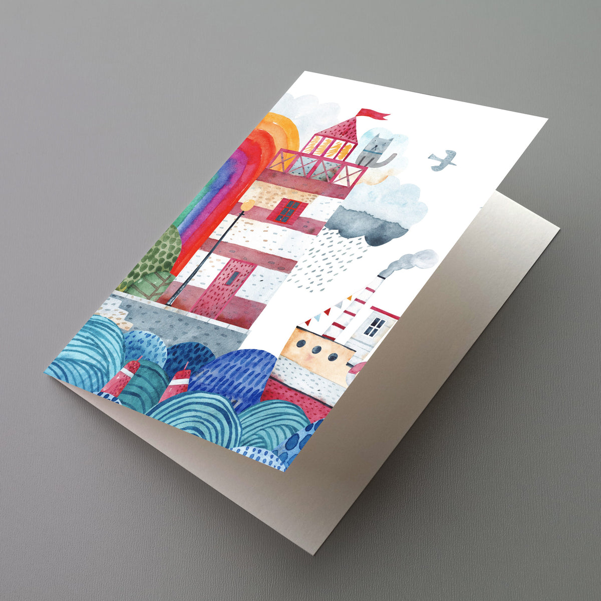 Box of 24 cards featuring a watercolor coastal harbor scene with a striped lighthouse and steamboat.