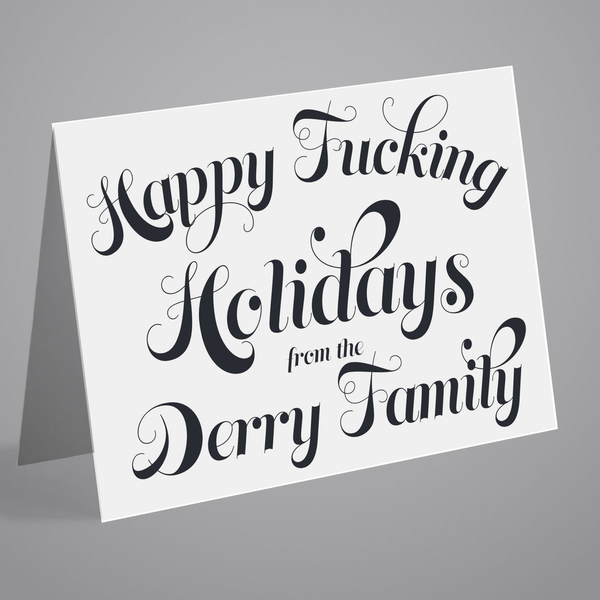 Set of 24 landscape Christmas cards printed with "Happy Fucking Holidays from the [Surname] Family" in black script.