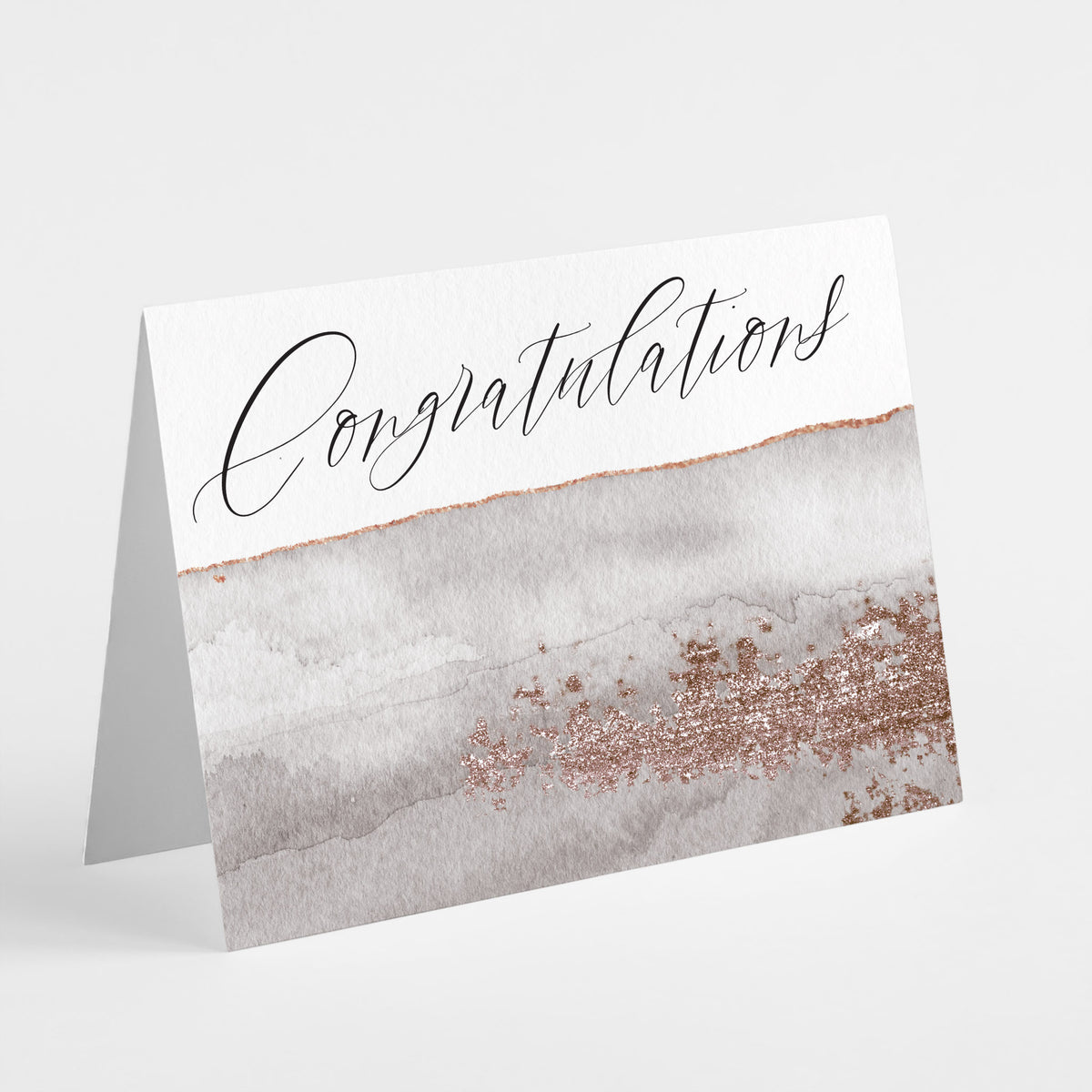 Single-design card set reading "Congratulations" in script lettering with rose-gold-colored accents and neutral watercolor wash.