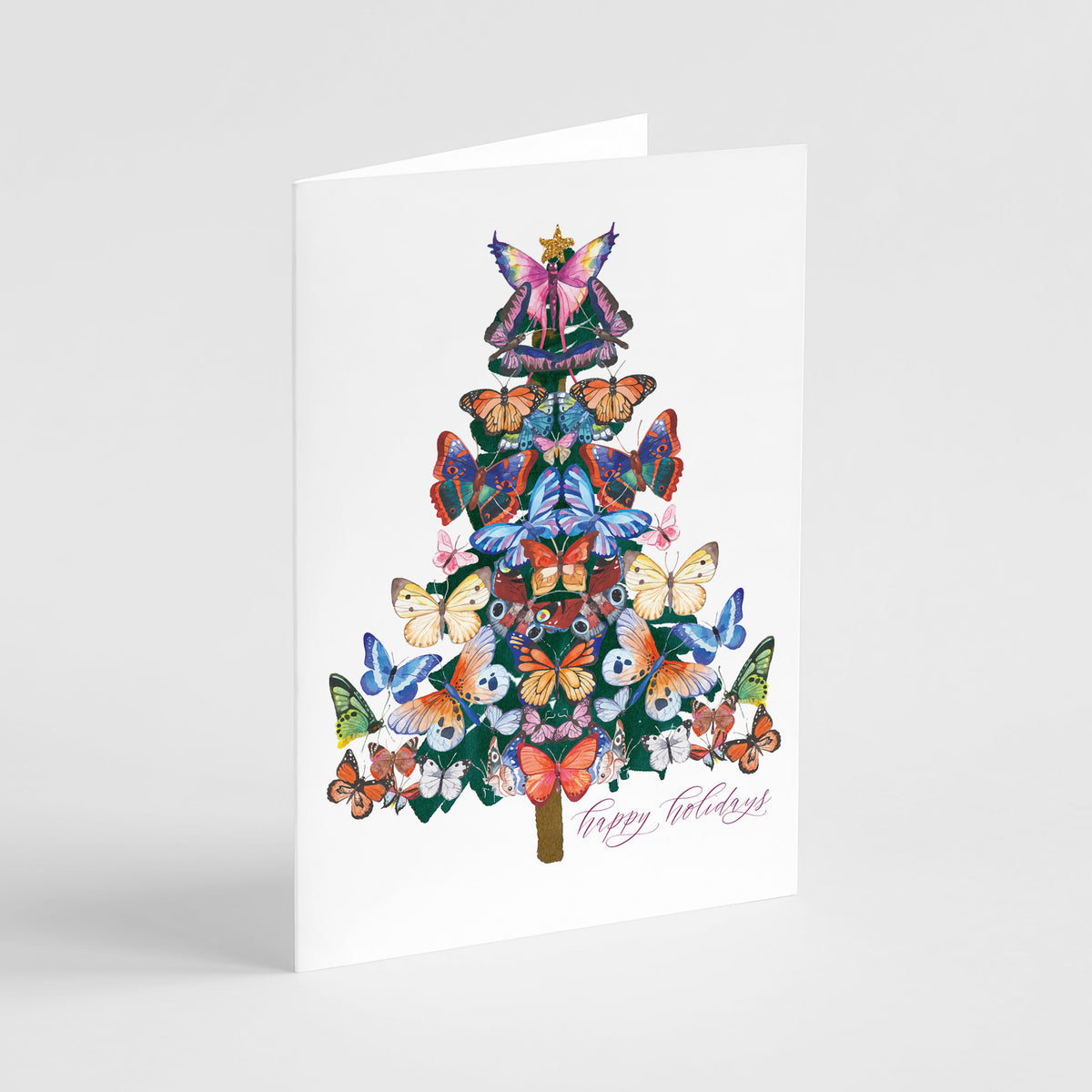Christmas card showing a tree shape built from tiered, mirrored butterflies in orange, blue, green, cream, and pink tones.