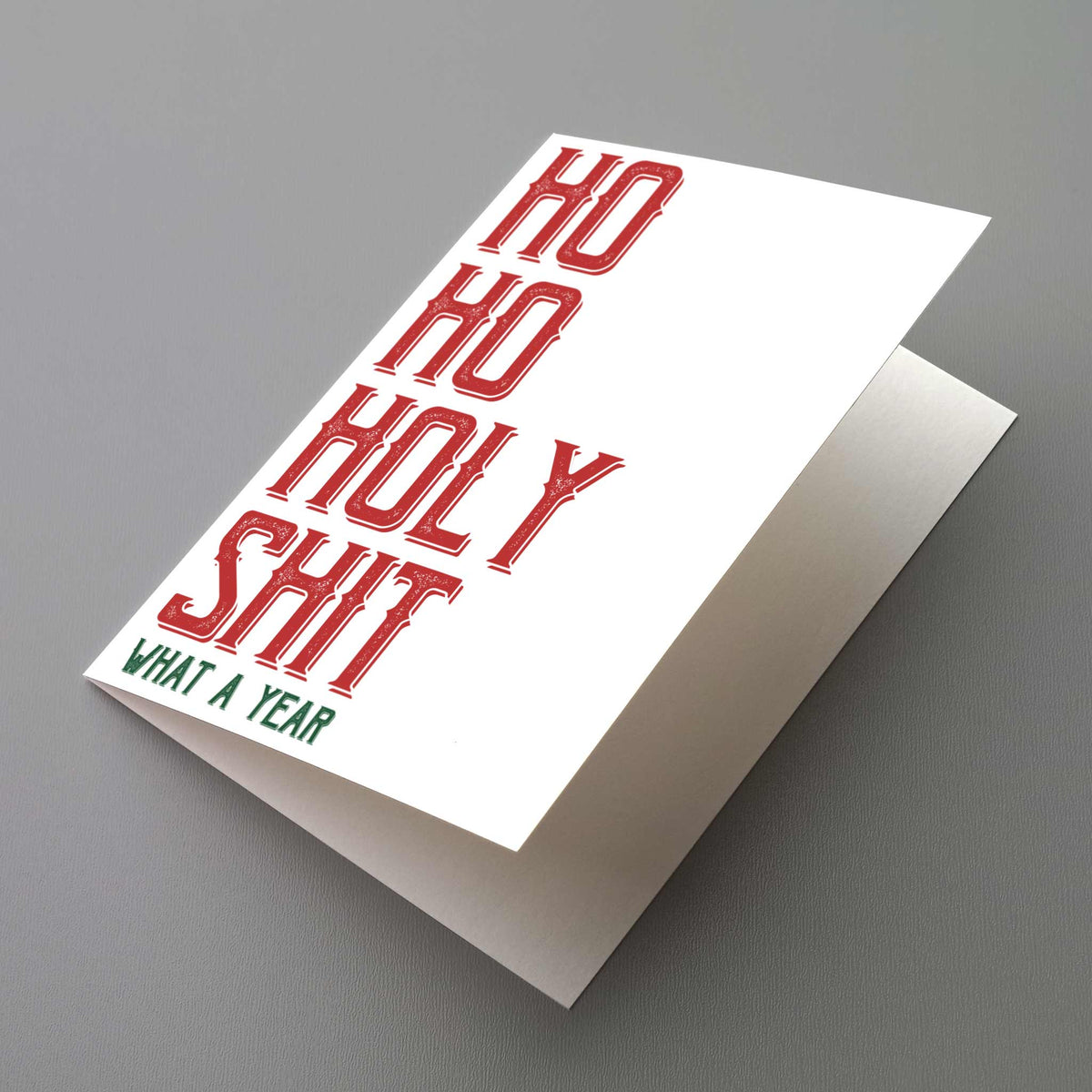 Single-design holiday card with bold red slab-serif capitals spelling "Ho Ho Holy Shit" on a white background.