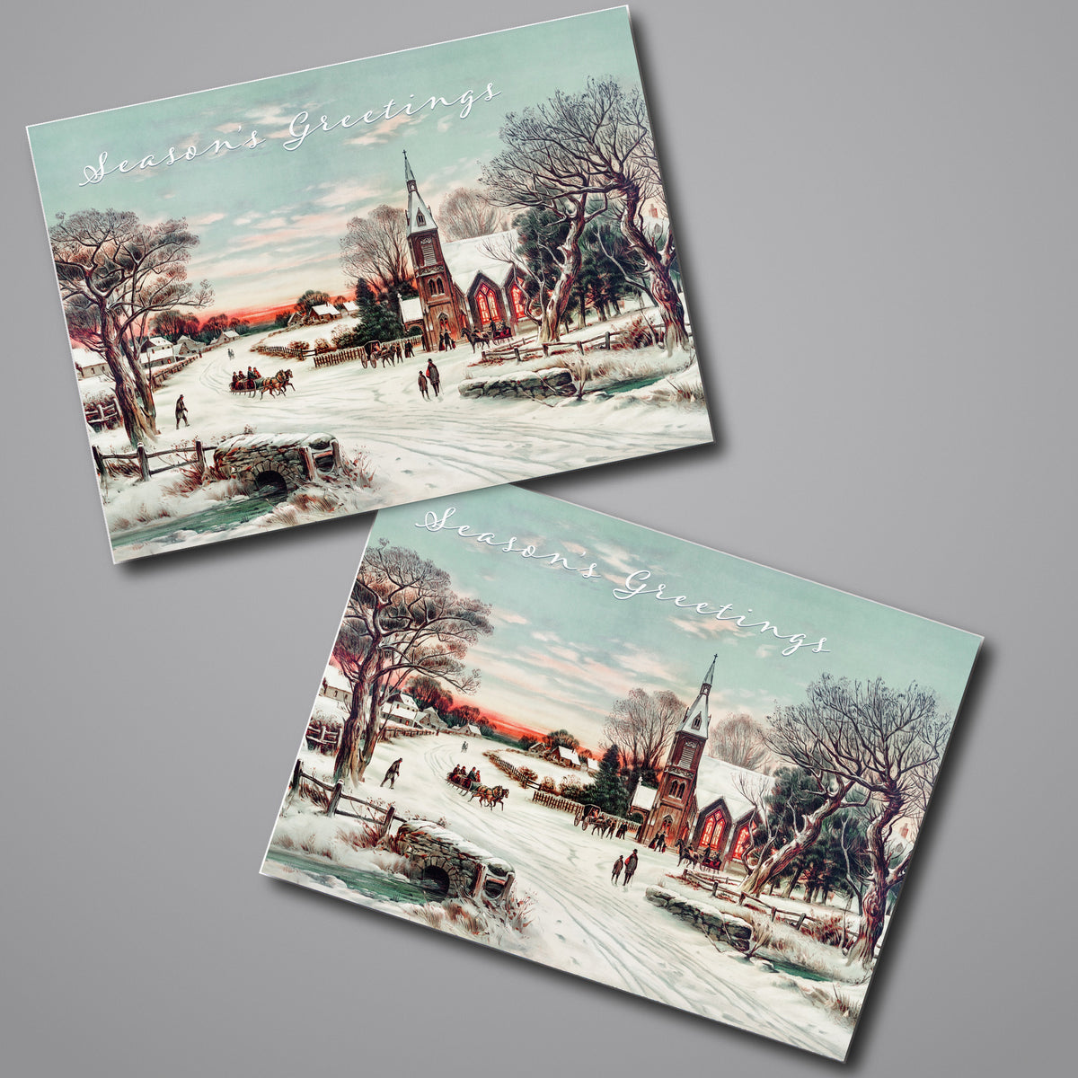 Card set featuring a snowy village scene with an illuminated church, horse-drawn sleigh, and "Season's Greetings" script.