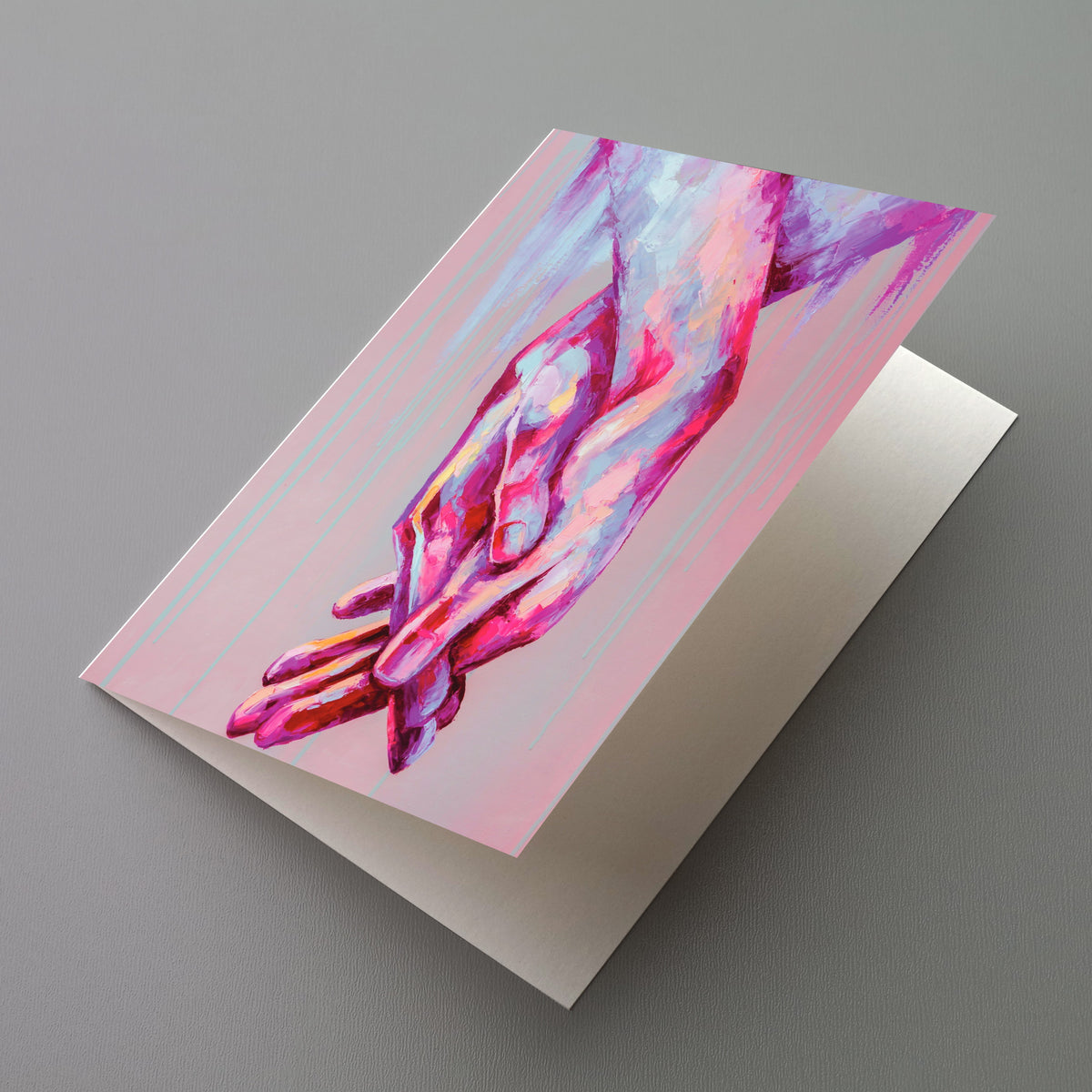 Card set featuring a painted illustration of interlocked hands in pink, magenta, and lavender on a muted dusty-rose field.