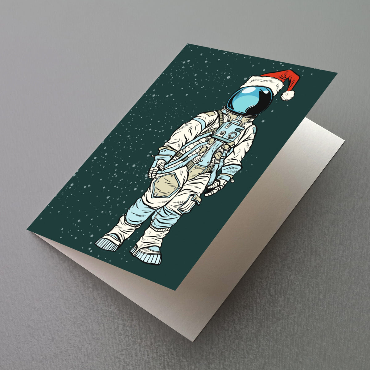White spacesuit astronaut in red Santa hat on green star-dotted card, pop art linework design.