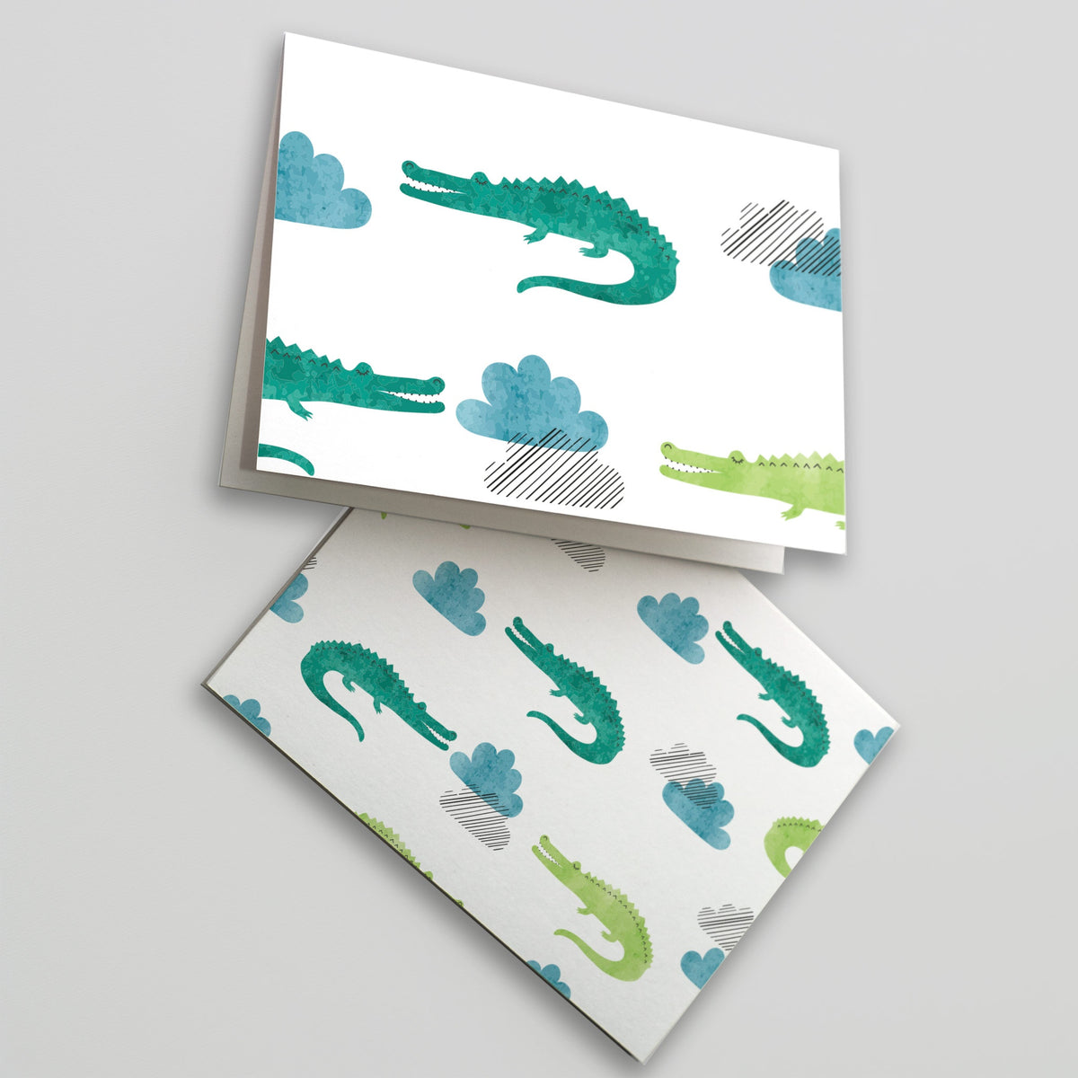 Card set with allover teal-green and yellow-green crocodilian illustrations on white backgrounds.