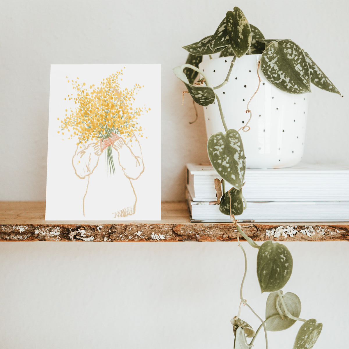 Illustrated notecard set showing a person holding a bunch of yellow and green flowers.