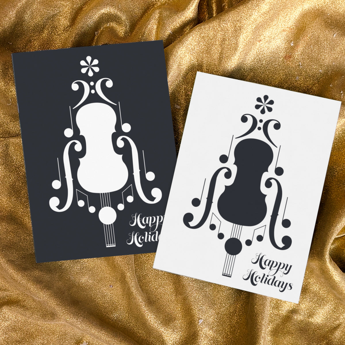 Card set with two reversing designs, each centered on a symmetrical musical notation graphic and "Happy Holidays" in script.