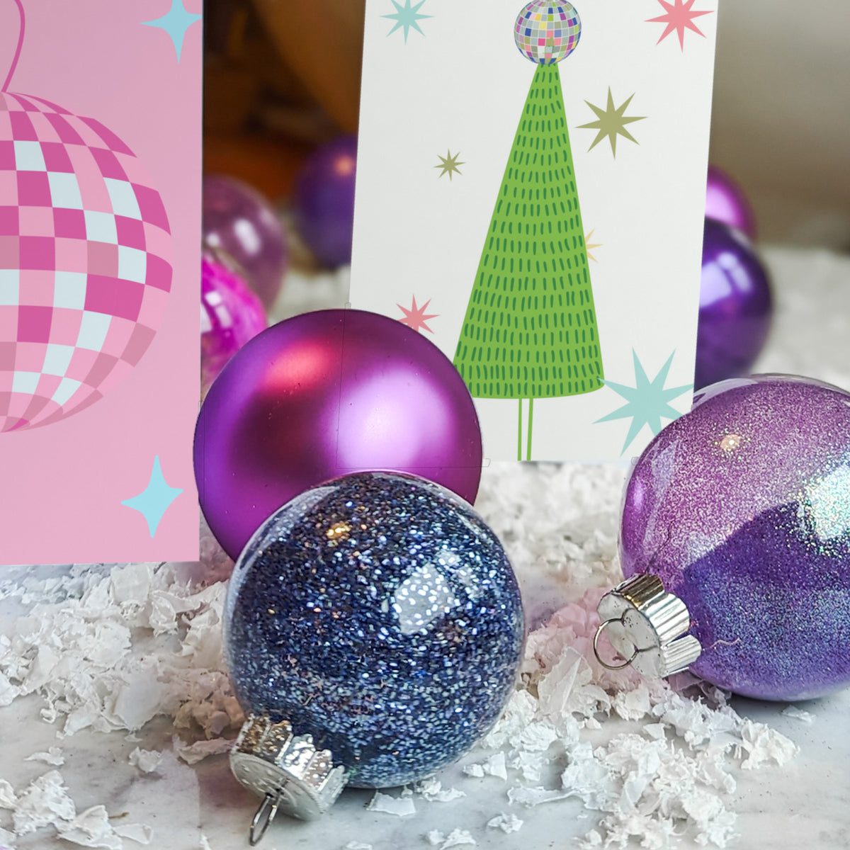 Card holiday set with six designs: disco ball ornaments and decorated Christmas trees on colorful backgrounds.