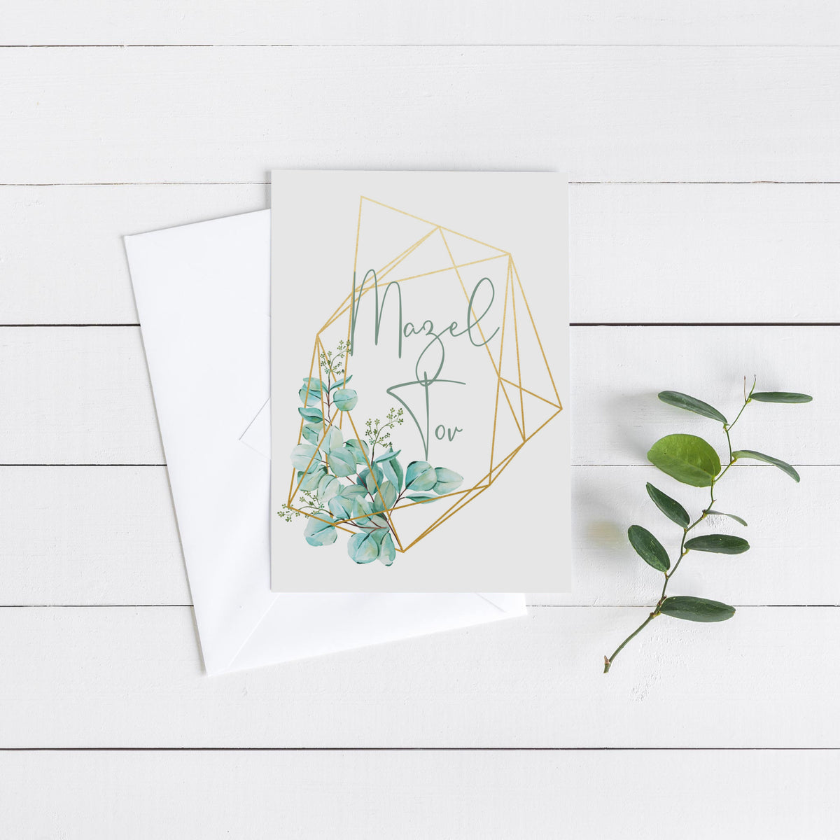 Boxed set of 24 Mazel Tov greeting cards with eucalyptus wreath accents and geometric polygon frames.