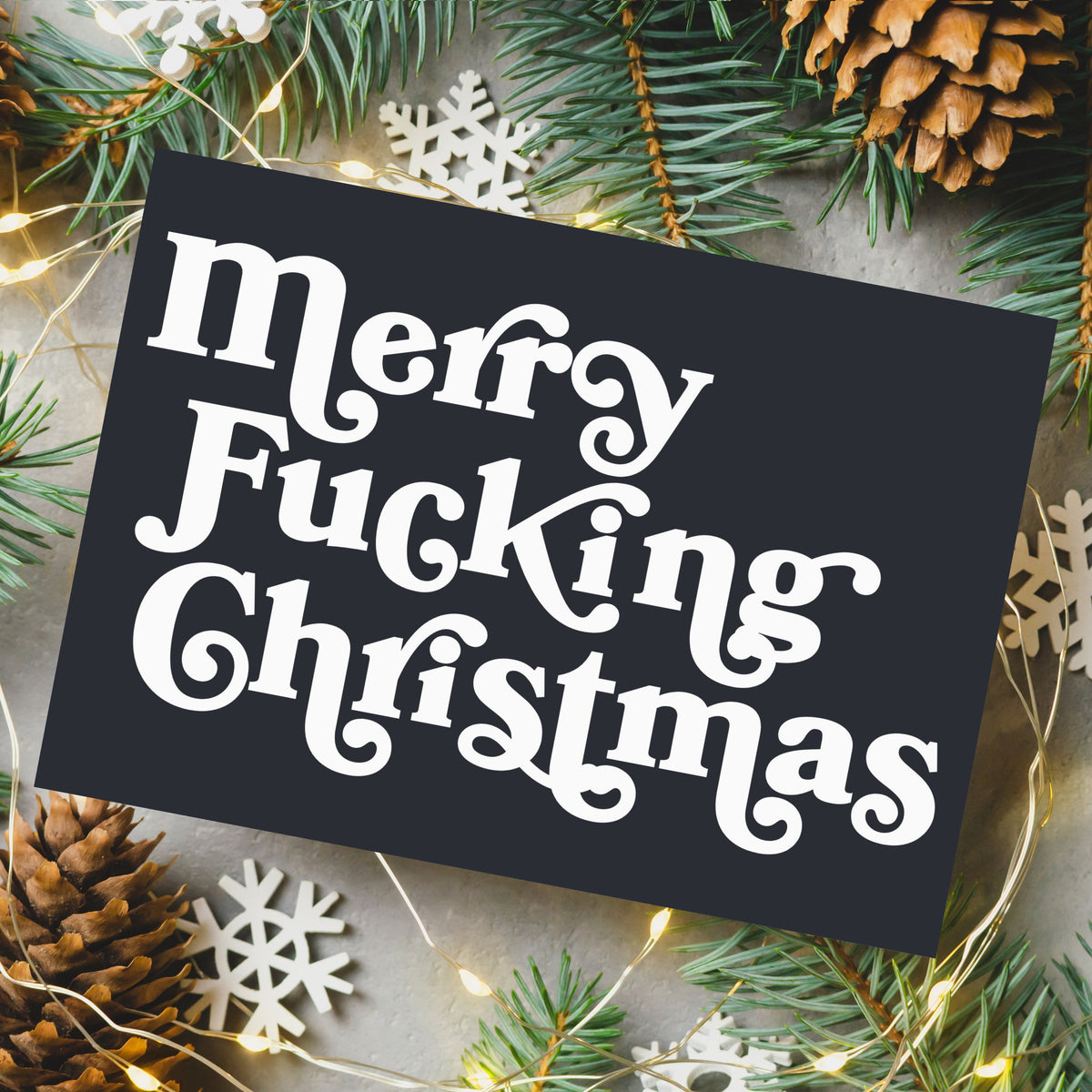 Two-design Christmas card set, 12 cards each, with bold white display text on near-black charcoal backgrounds.