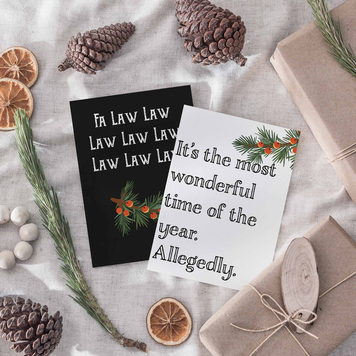 Two-design Christmas card set; white card reads "It's the most wonderful time of the year. Allegedly." in black slab-serif.