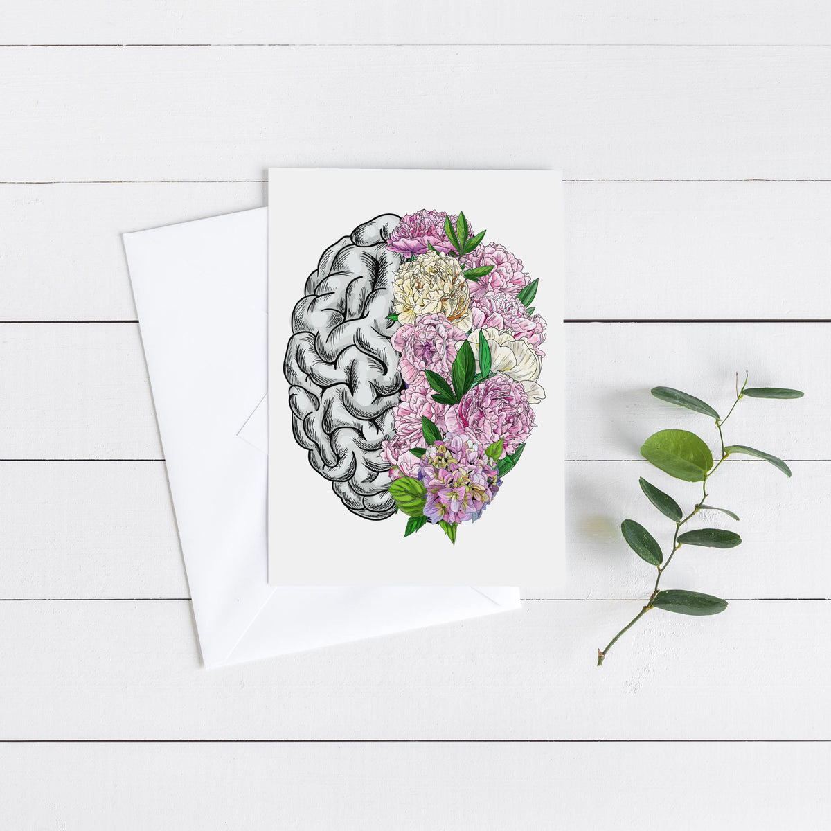 Anatomical brain card design split at the midline between detailed gray linework and clustered pink and cream blooms.