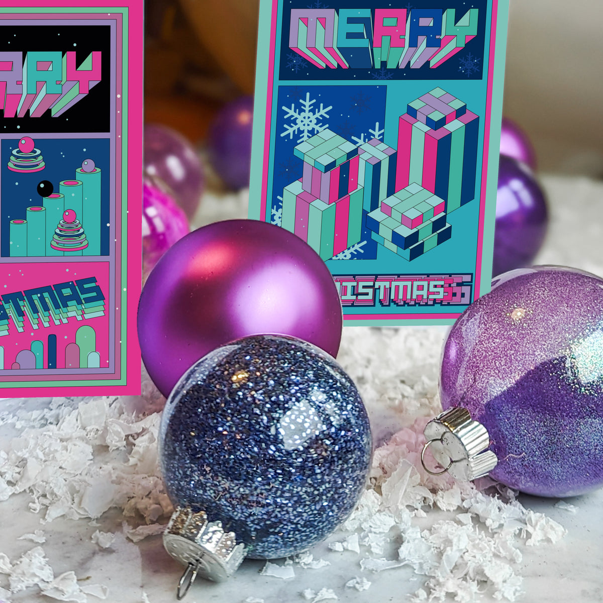 Four Christmas card designs with 8-bit-inspired typography and multicolor striped 3D block letters spelling Merry Christmas.