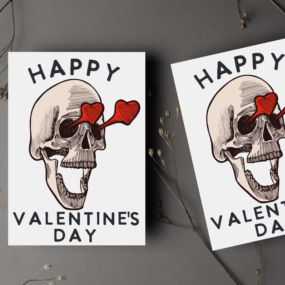 Valentine's Day card with a dark engraving-style human skull wearing red heart-shaped glasses, white background, no border.