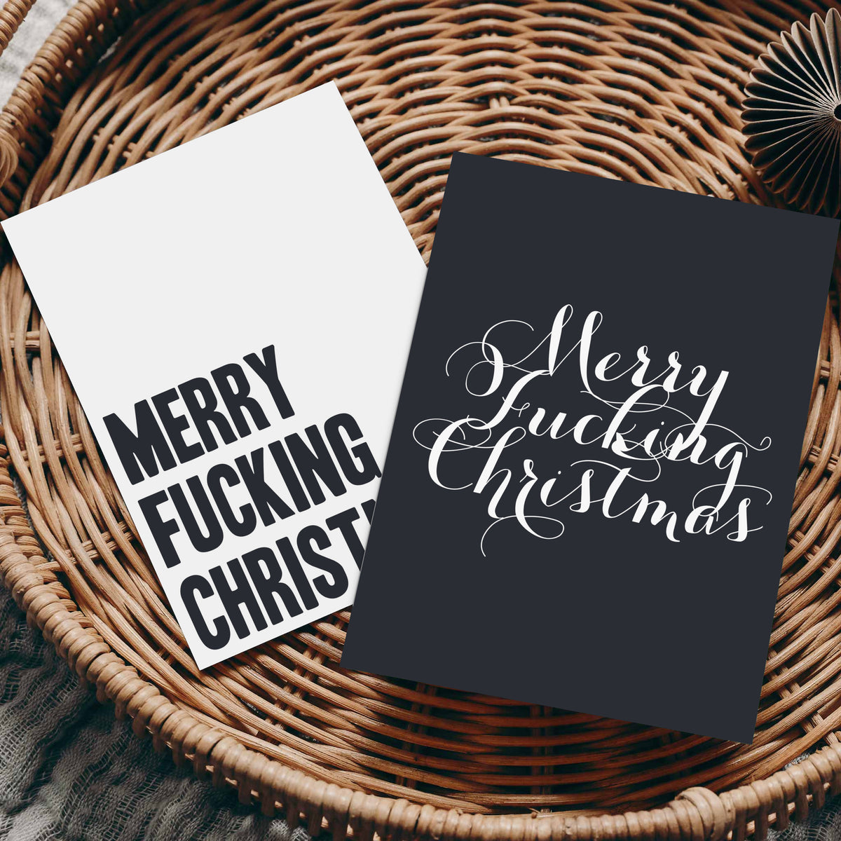 Set of 24 Christmas cards in four designs: two black cardstock, two white cardstock, bold and script typography.
