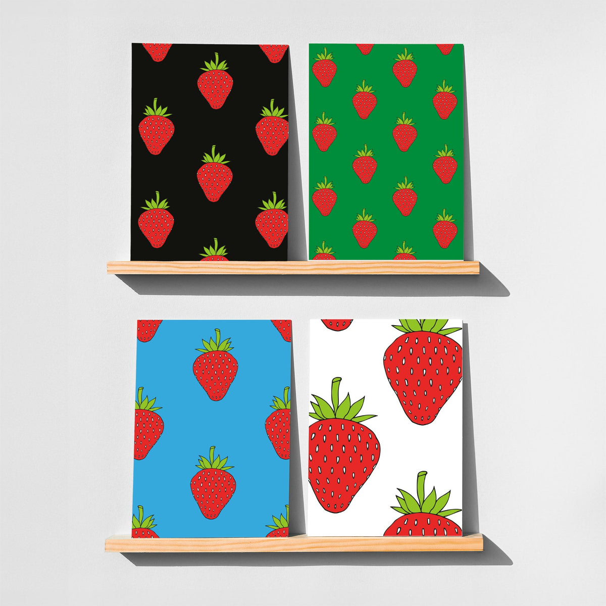 Card notecard set with repeating strawberry pattern in red, green, and black.