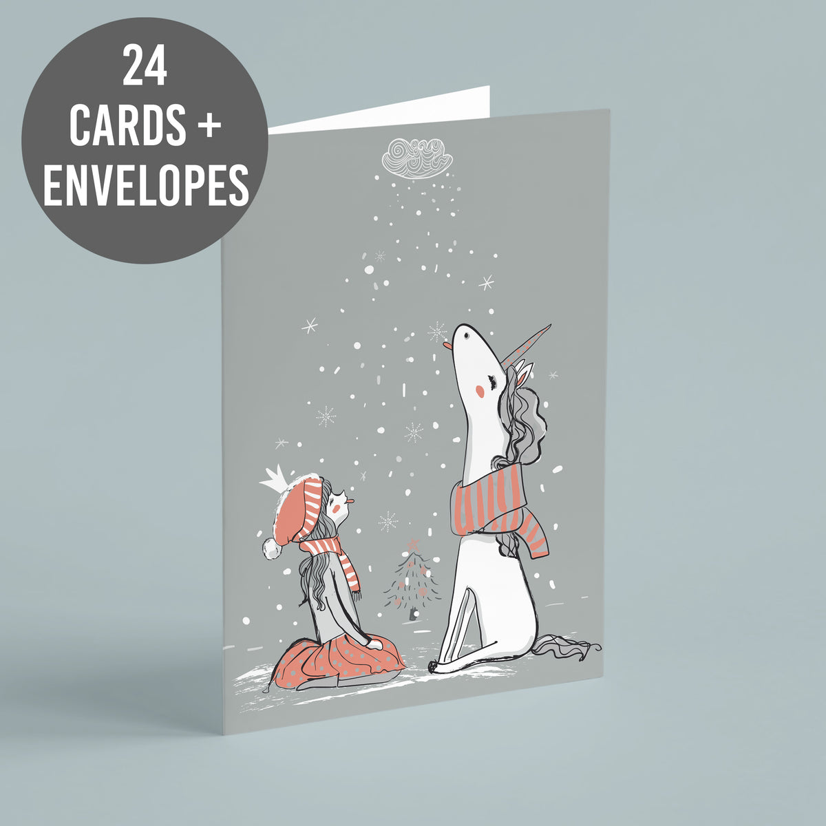 Greeting cards, single design, girl kneeling beside a unicorn in snow with a cloud and falling snowflakes.