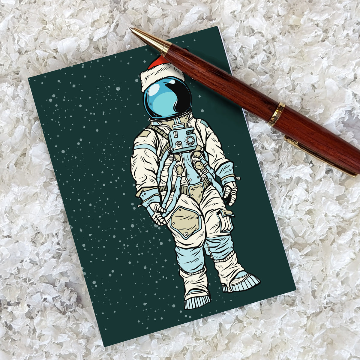 Christmas card set of 24 featuring a full-body astronaut wearing a Santa hat over a white helmet.
