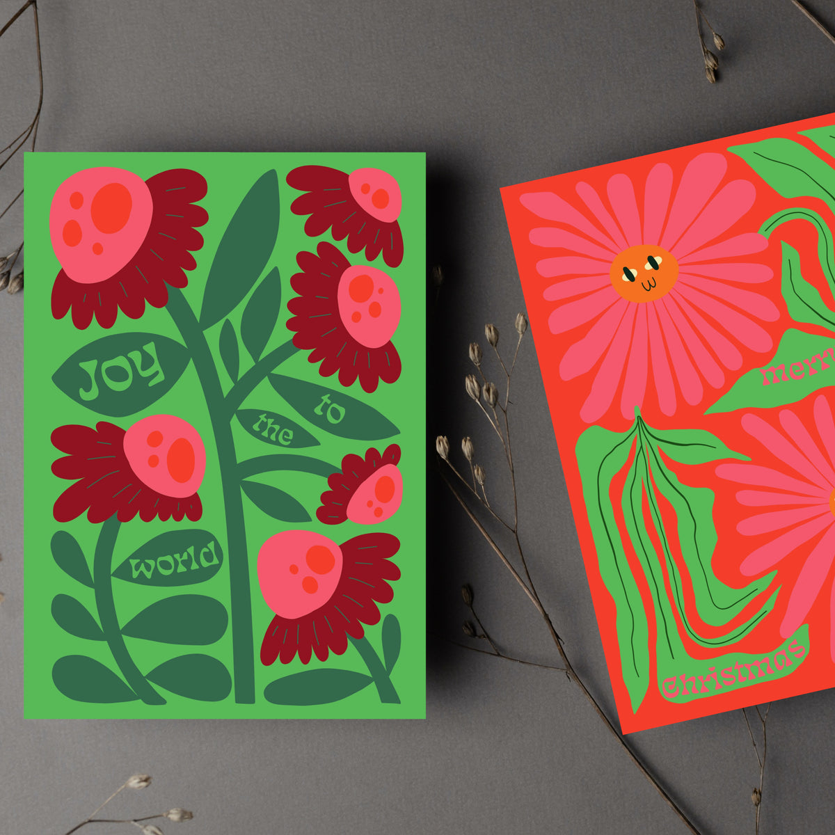 Christmas cards with flat-color botanical art and phrases including "Merry Christmas" and "Joy to the World."