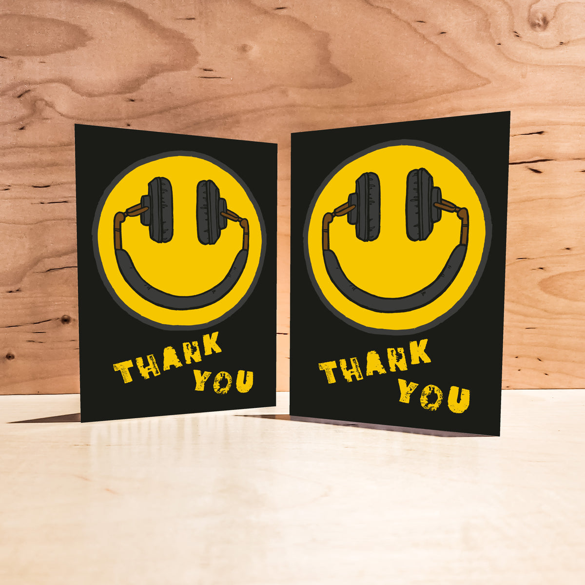 Card set featuring a high-contrast yellow and black smiley face with headphone design.