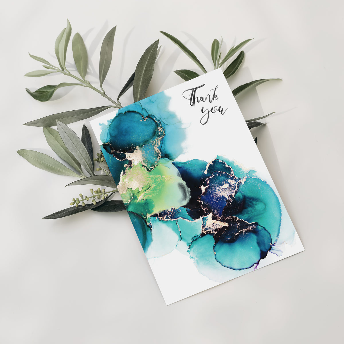 Card set featuring four coordinating abstract designs with gold veining and black script text.