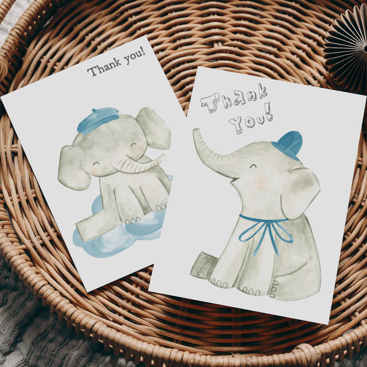Watercolor elephant notecard set with one design showing an elephant on a cloud, another with a blue hat and bow.