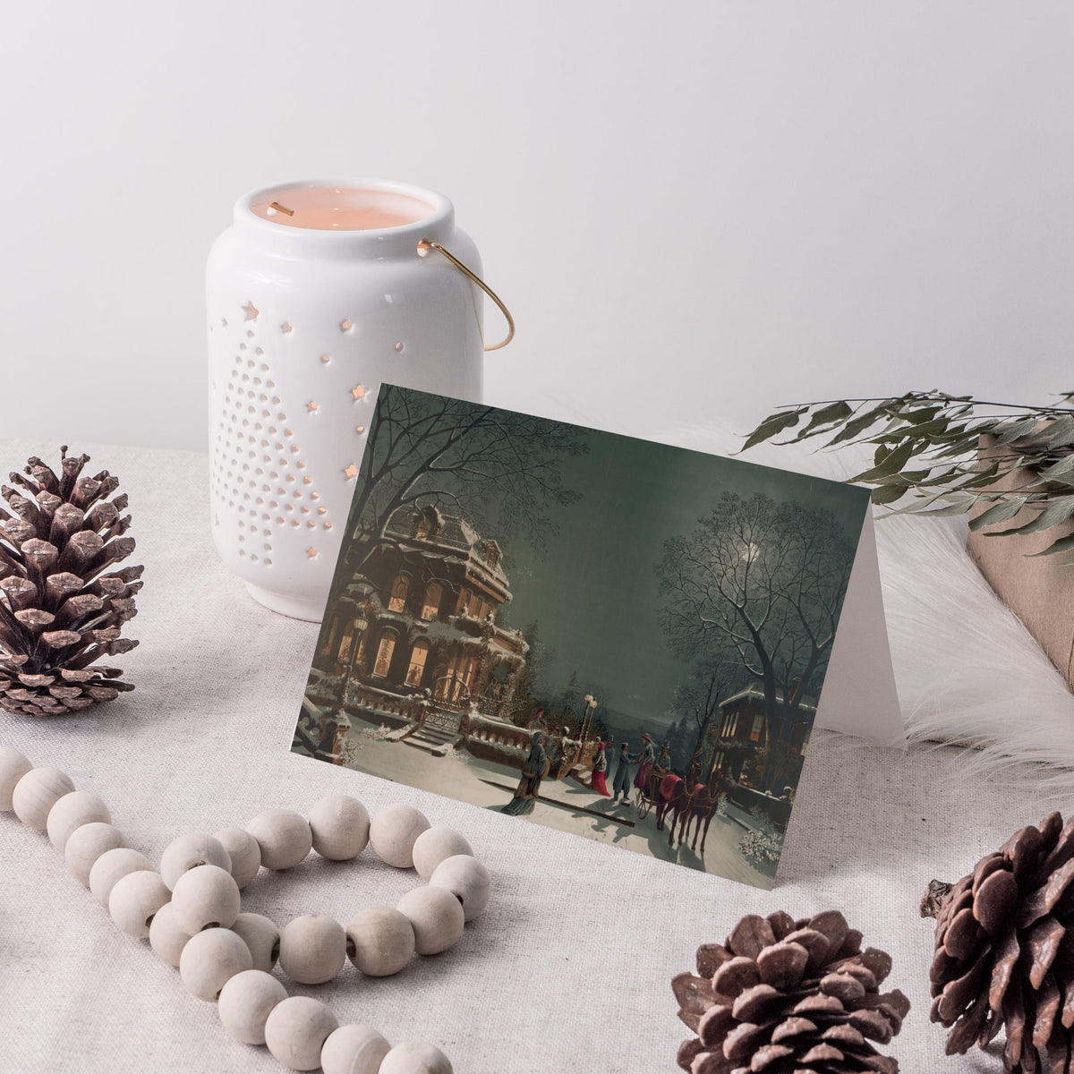 Card Christmas set with a moonlit Victorian street scene, figures in period dress, and a decorated mansion.