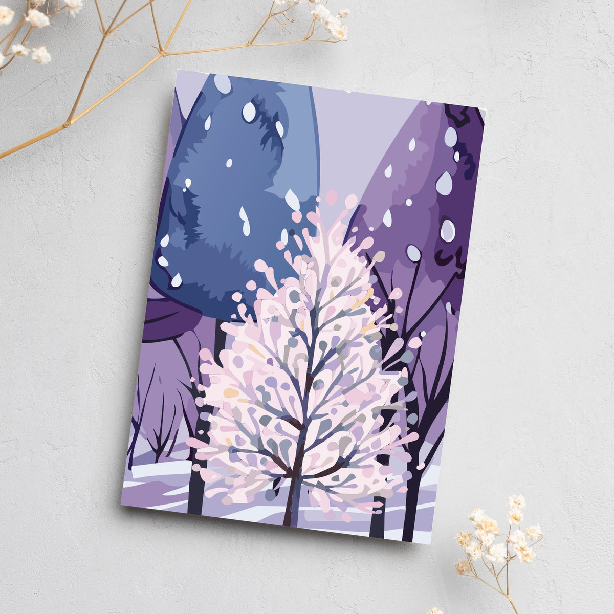 Christmas cards with flat-color digital illustrations of snowy evergreen scenes in purple and pink tones.