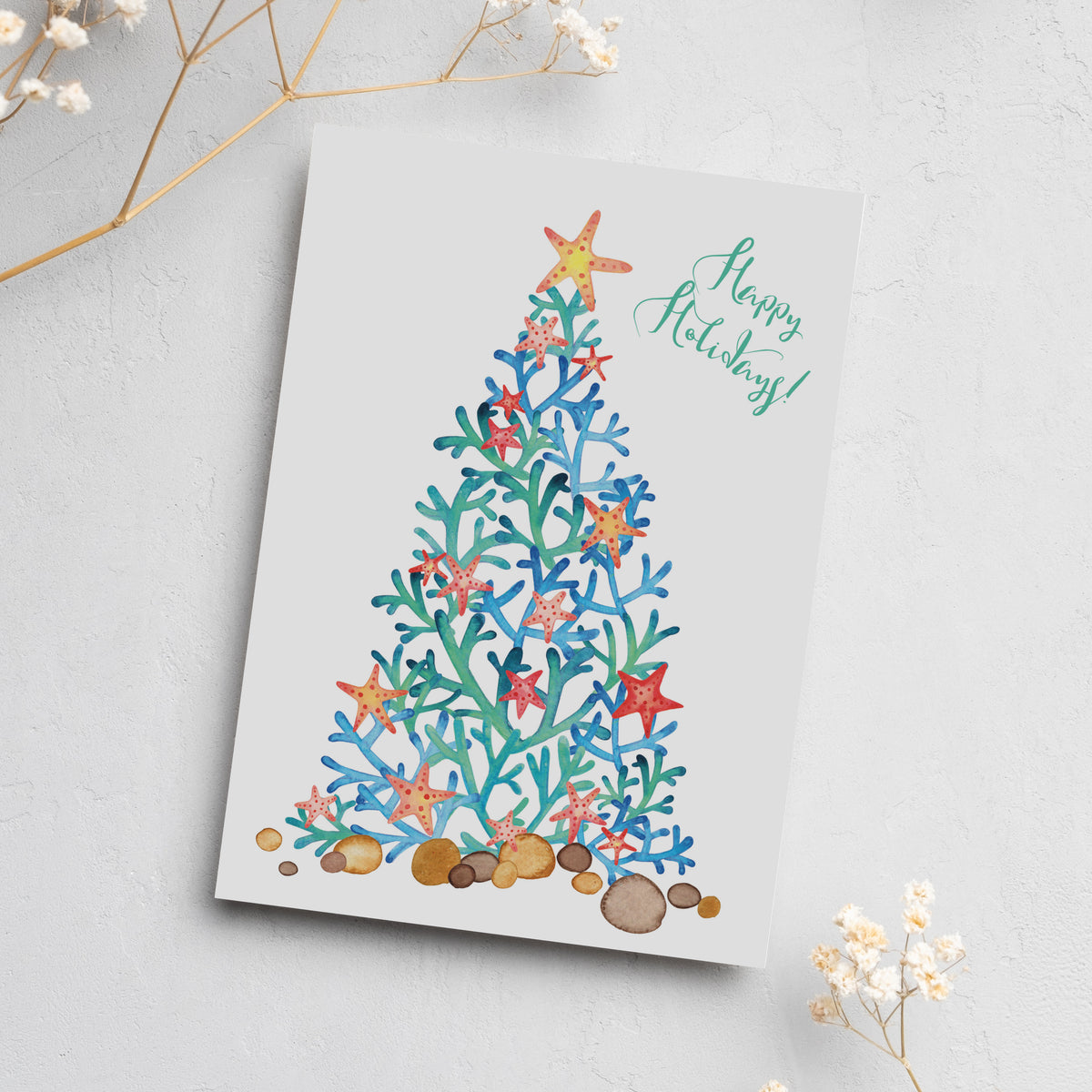 Coastal beach Christmas card set with a teal and blue coral branch tree decorated with orange, pink, and red starfish.