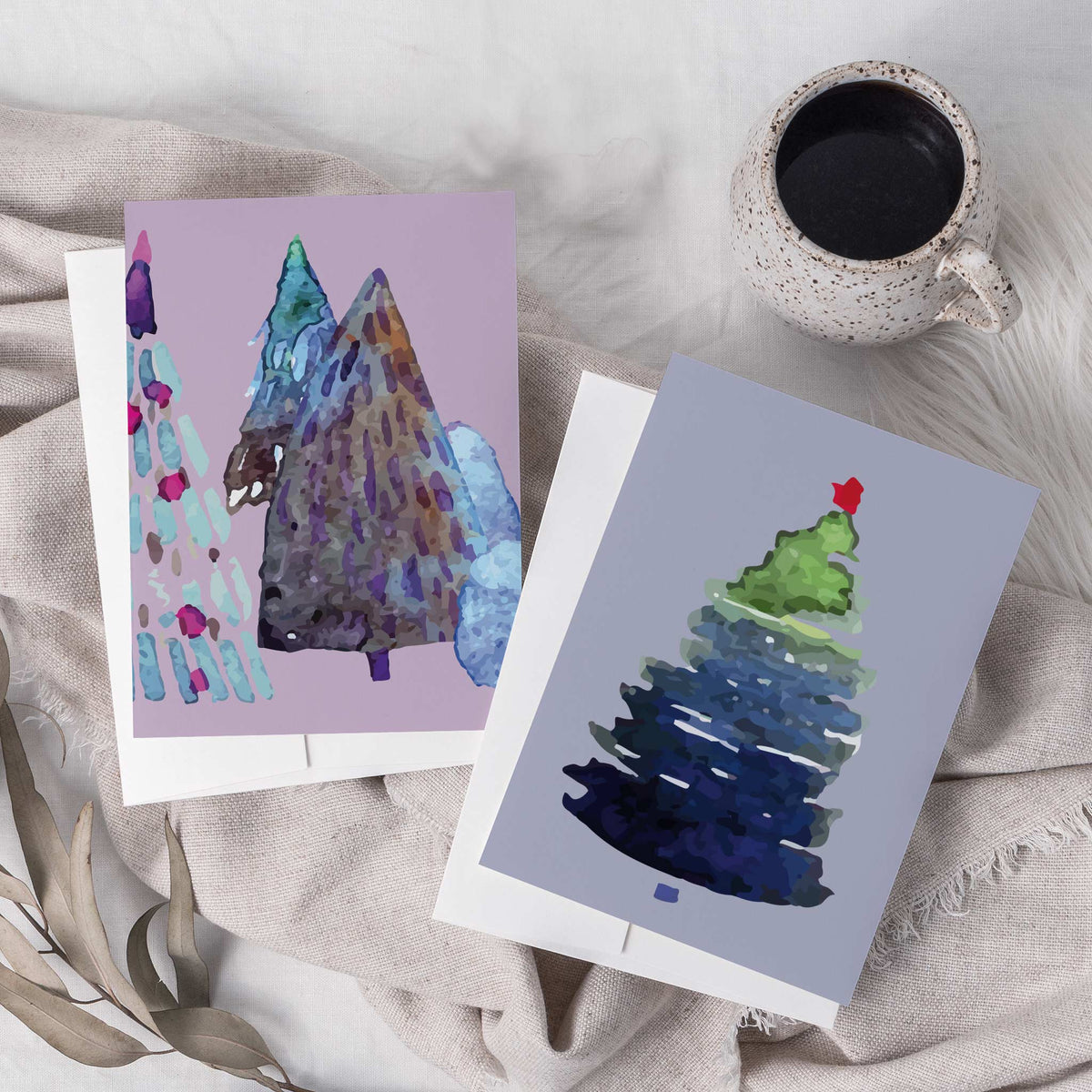 Card set with 12 watercolor-style Christmas tree designs, two cards per design.