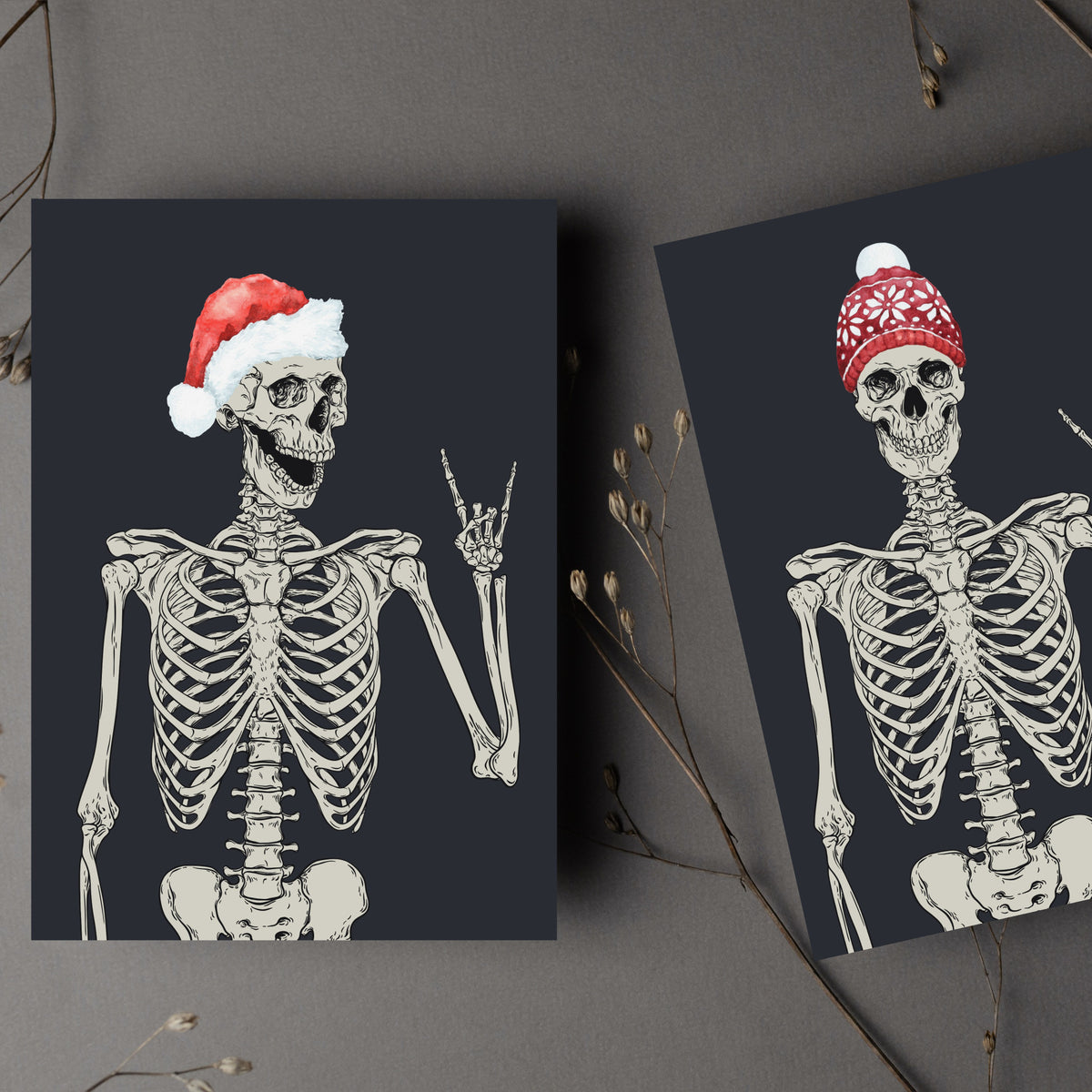 Holiday card set with illustrated skeleton wearing a striped Santa hat and making a rock-on hand gesture.