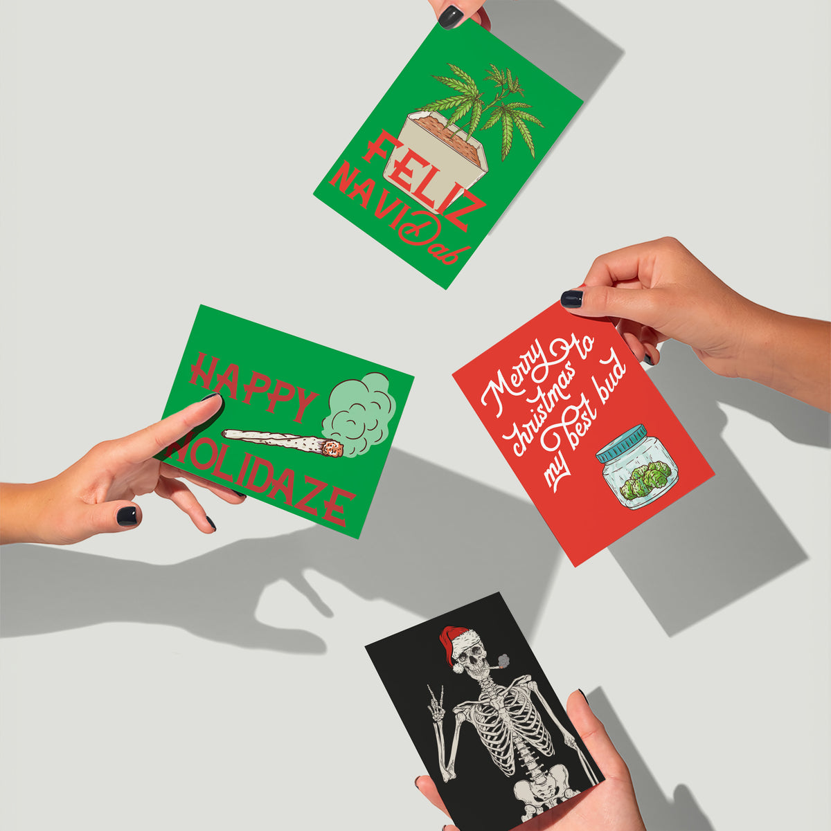 Twelve cannabis holiday card designs including menorah, Christmas tree, and joint illustrations.